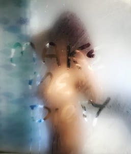 Nude taken in steamy bathroom mirror in which I’ve written ‘Make me dirty’ in the condensation