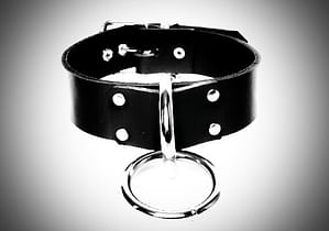 Black and white photo of bondage collar with ring